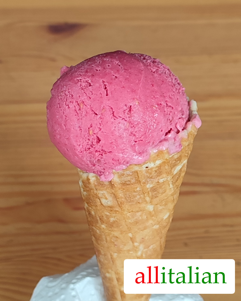 Homemade raspberry ice cream on a cone