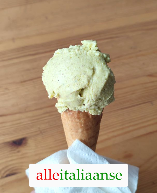 A homemade Italian pistachio gelato on an ice cream cone