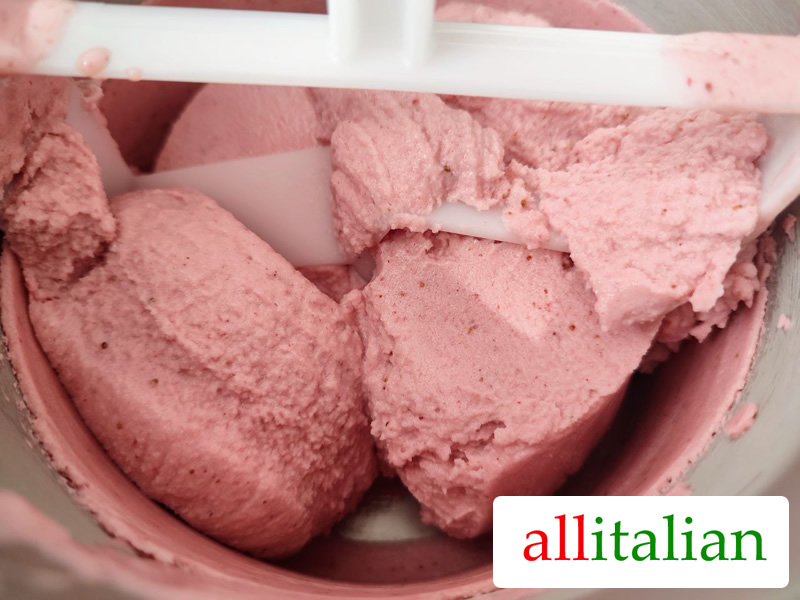 Strawberry ice cream ready in the basket of the ice cream maker