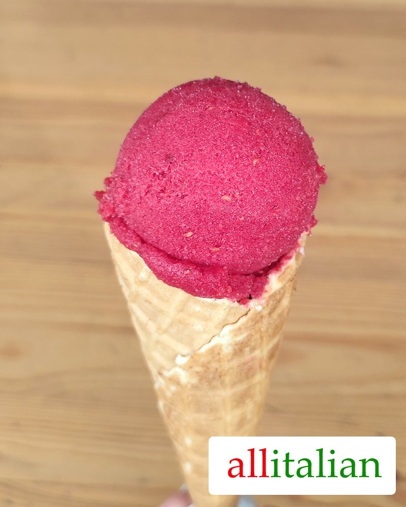 Homemade raspberry sorbet on an ice cream cone