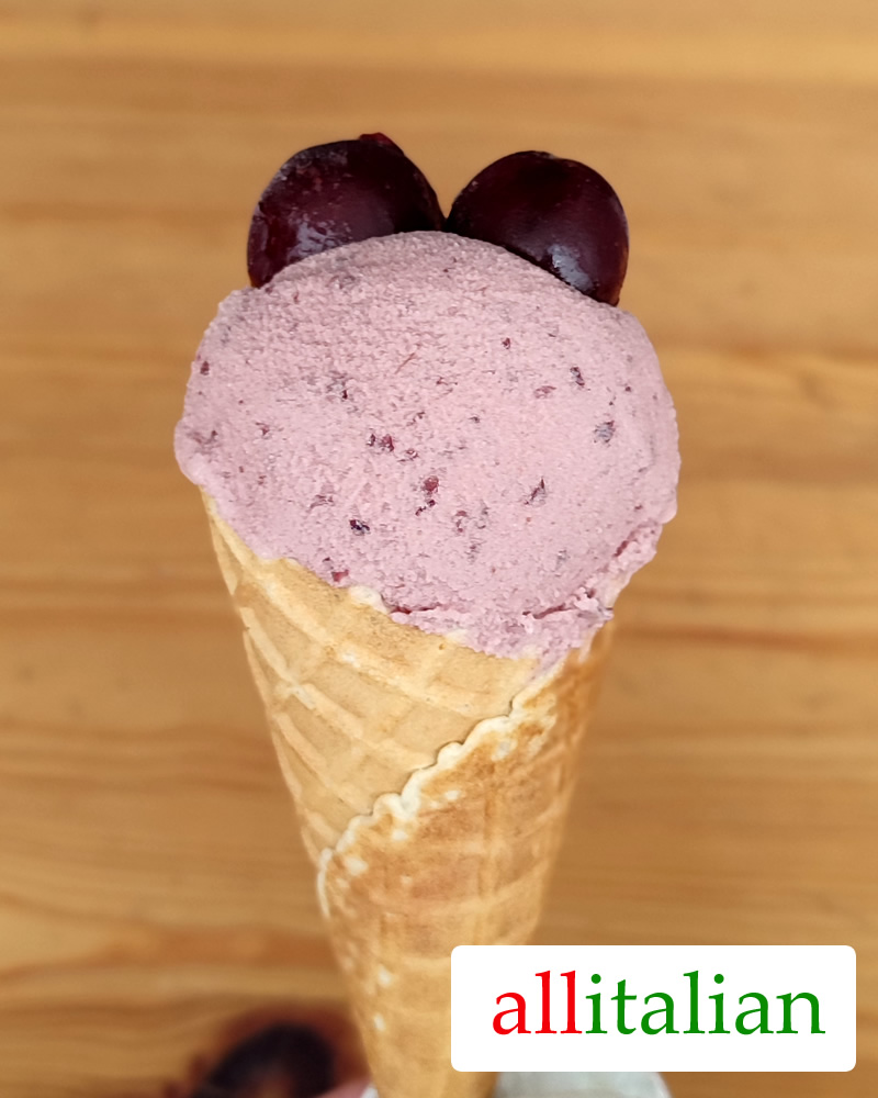 Homemade cherry ice cream on a cone