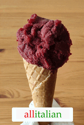 A homemade cherry ice cream on a cone