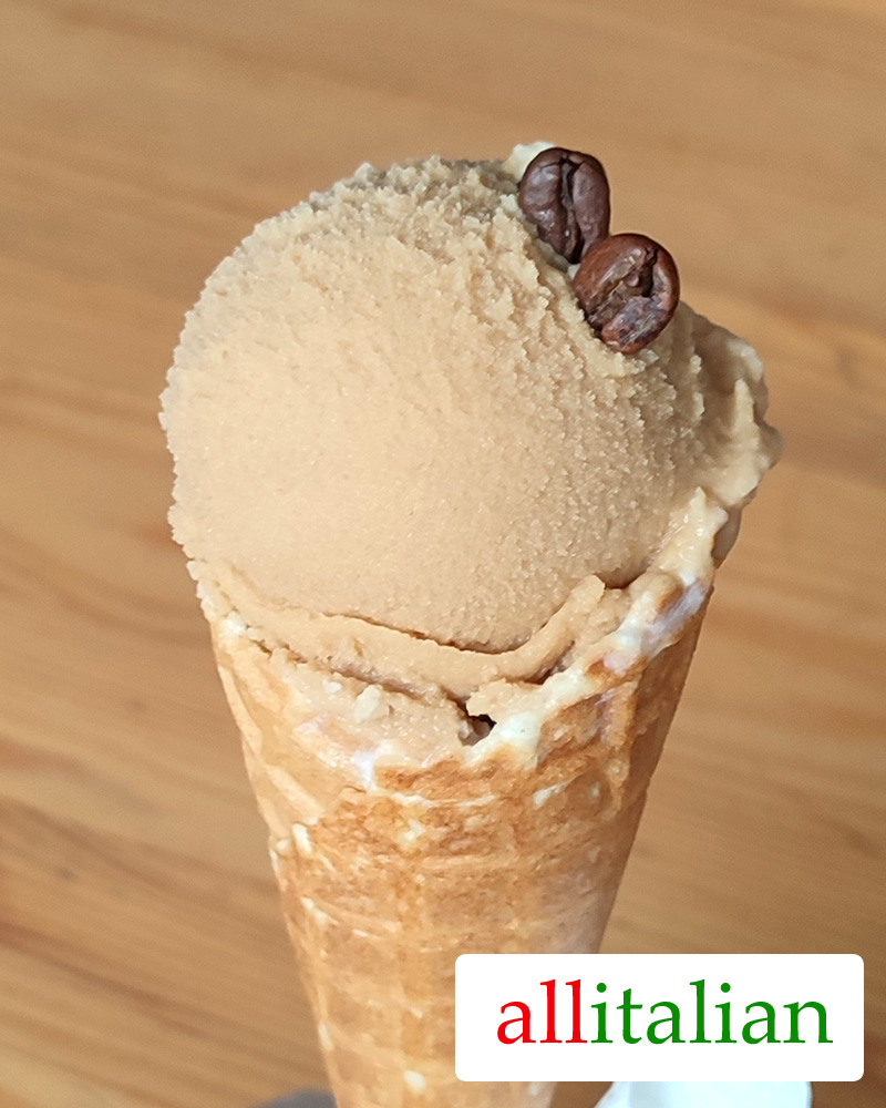 Homemade coffee ice cream with honey on a cone