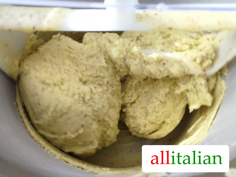 Homemade pistachio ice cream ready in the bowl of the ice cream maker