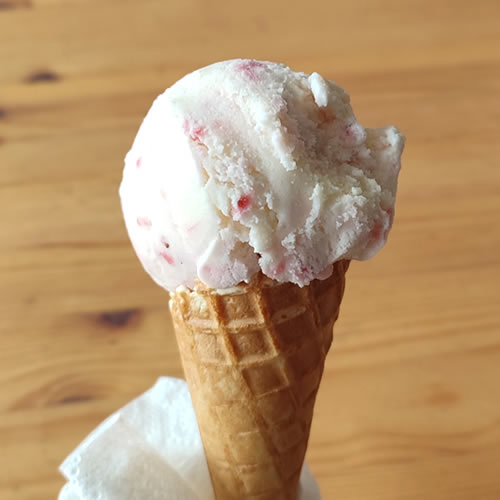 A strawberry cheesecake ice cream cone