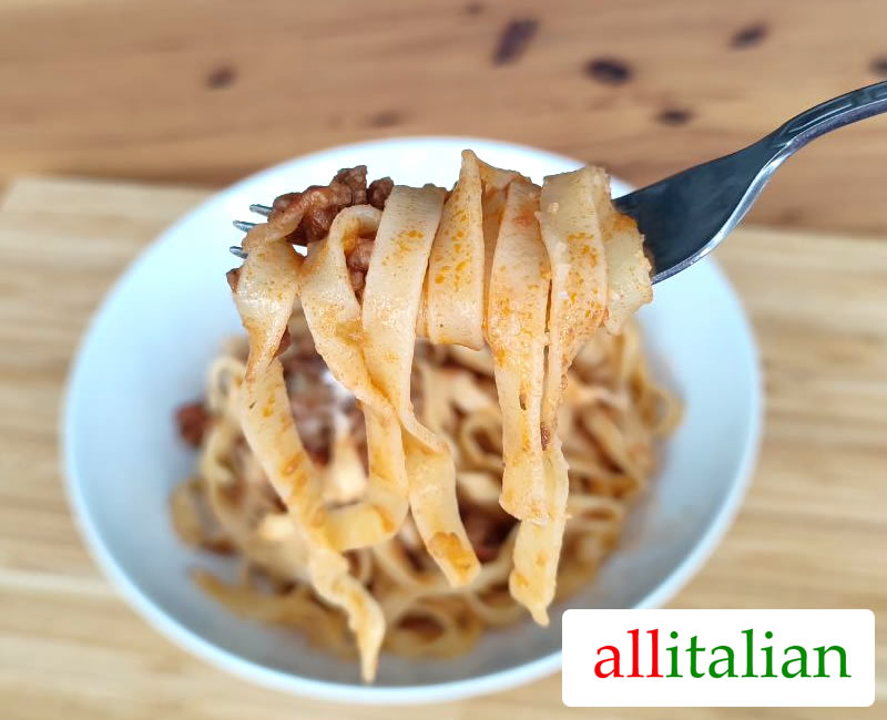 Detail of tagliatelle with Bolognese sauce on a fork