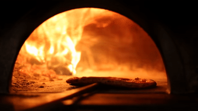 Baking pizza in the wood oven